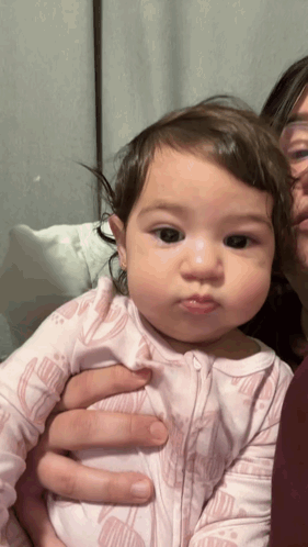 Woman Holding Baby In Pink Floral Outfit GIF