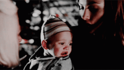 Woman Holding Baby In Striped Hat GIF