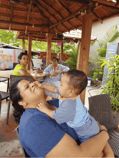 Woman Holding Baby Reaching For Face GIF