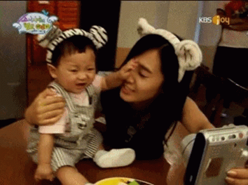Woman Holding Baby With Zebra Headband GIF
