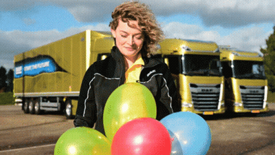 Woman Holding Balloons In Front Of DAF Truck GIF
