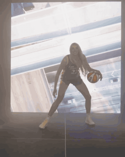 Woman Holding Basketball With Number 3 On Shirt GIF