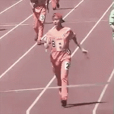 Woman Holding Baton Crossing Finish Line On Track GIF