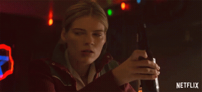 Woman Holding Beer With Netflix Logo GIF