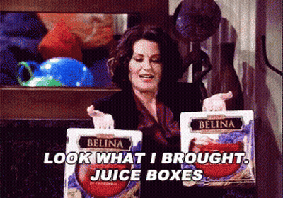 Woman Holding Belina Juice Boxes Saying Look What I Brought GIF