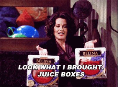 Woman Holding Belina Juice Boxes Saying Look What I Brought GIF