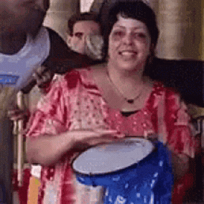 Woman Holding Blue Drum Smiling GIF