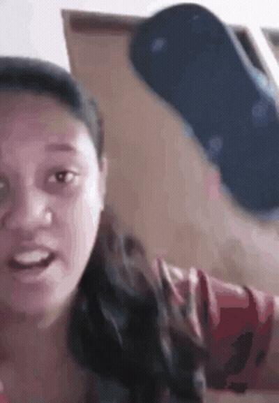 Woman Holding Blue Flip Flop In Front Of Face GIF