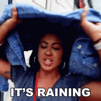 Woman Holding Blue Jacket Over Head Saying It's Raining GIF