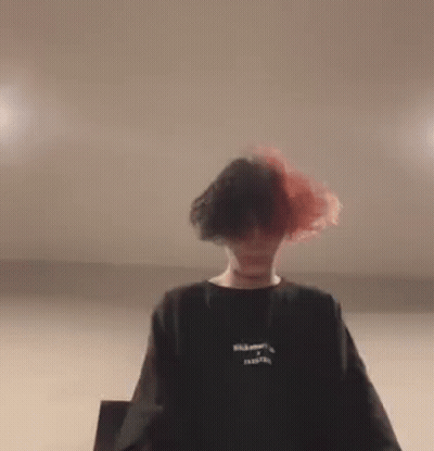 Woman Holding Blue Pillow Over Head GIF