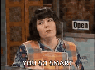 Woman Holding Book In Front Of Open Sign GIF