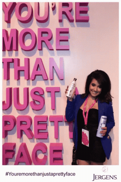 Woman Holding Bottle In Front Of Sign You're More Than Just Pretty Face GIF