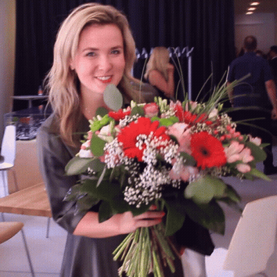 Woman Holding Bouquet Of Flowers GIF