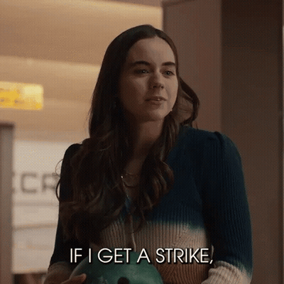 Woman Holding Bowling Ball Talking About Strike GIF