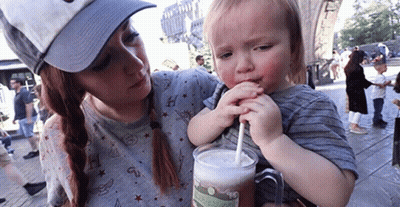 Woman Holding Boy Drinking From Mug GIF