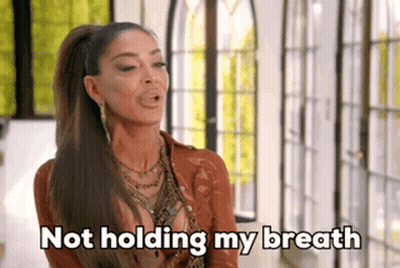 Woman Holding Breath With Ponytail And Necklace GIF