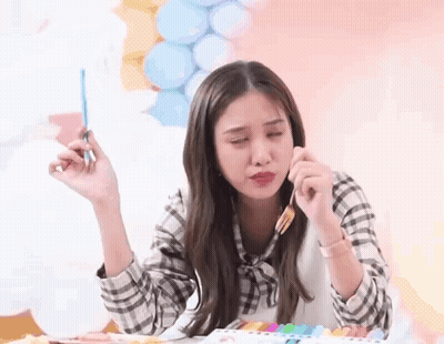 Woman Holding Brush At Table With Balloons GIF