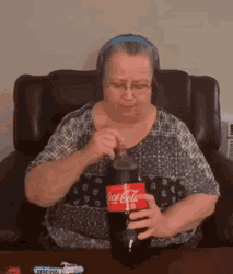 Woman Holding Bursing Coke Bottle GIF