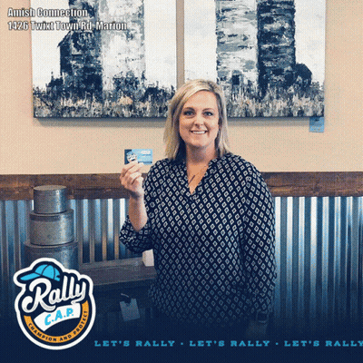 Woman Holding Card In Front Of Rally C.A.P. Sign GIF