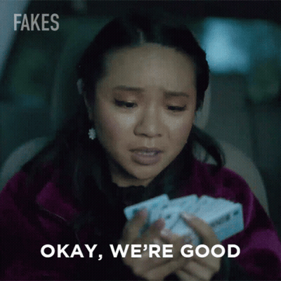 Woman Holding Cards Saying Okay We're Good GIF