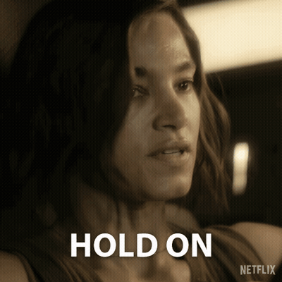Woman Holding Cell Phone Saying Hold GIF