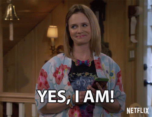 Woman Holding Cell Phone Saying Yes I Am GIF