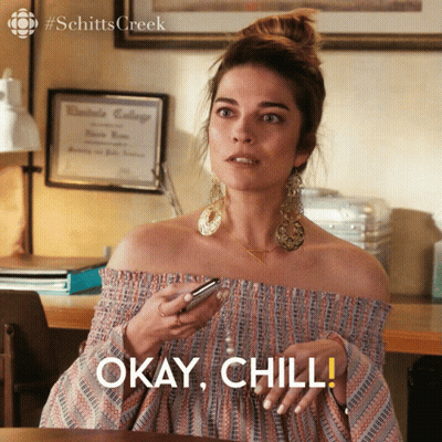 Woman Holding Cell Phone Says Okay Chill GIF