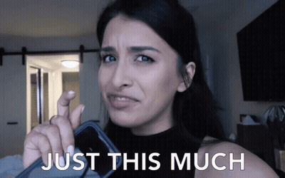 Woman Holding Cell Phone With Just This Much GIF