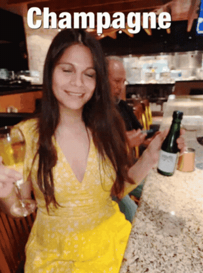 Woman Holding Champagne Bottle And Glass GIF