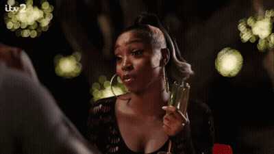Woman Holding Champagne Glass With Itv2 Sign GIF