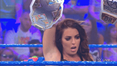Woman Holding Championship Belt In Wrestling Ring GIF