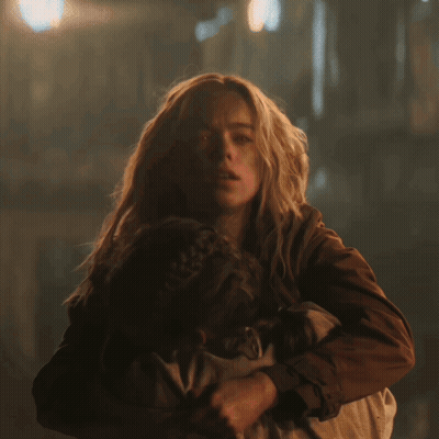 Woman Holding Child With Red Glowing Eyes GIF