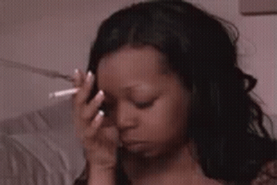 Woman Holding Cigarette To Forehead GIF