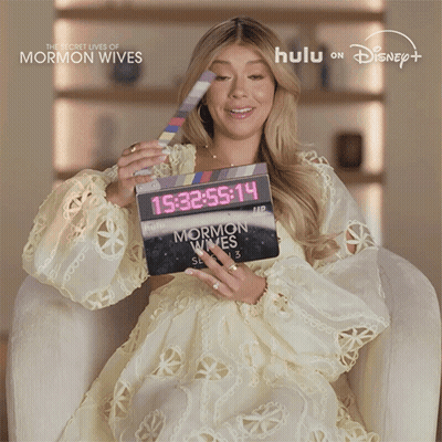 Woman Holding Clapper Board Saying Mormon Wives GIF