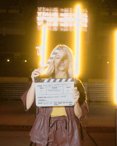 Woman Holding Clapper Board Saying The Show GIF