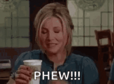 Woman Holding Coffee And Smiling GIF