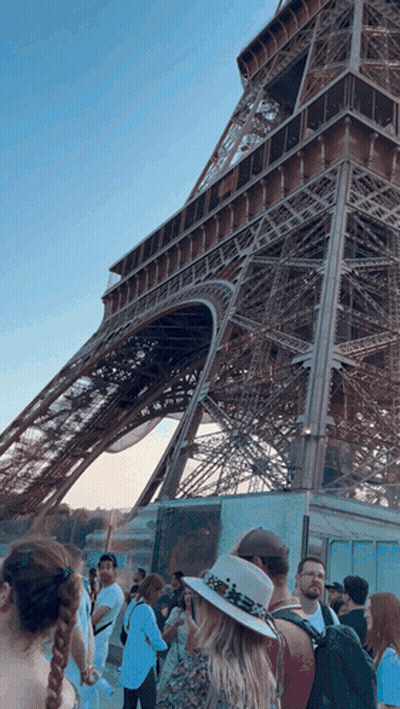 Woman Holding Coffee In Front Of Jewel Symphony Sign GIF