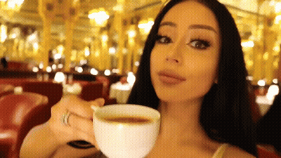 Woman Holding Coffee In Front Of Mirror GIF