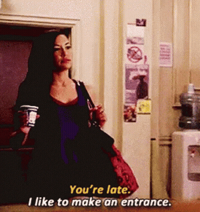 Woman Holding Coffee Says You're Late I Like To Make An Entrance GIF