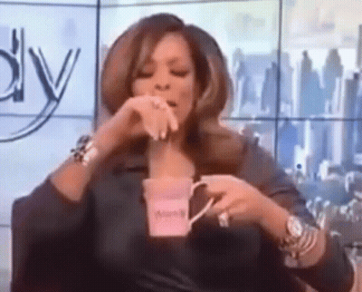 Woman Holding Coffee While Sitting GIF