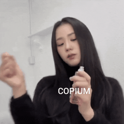 Woman Holding Copium Bottle GIF