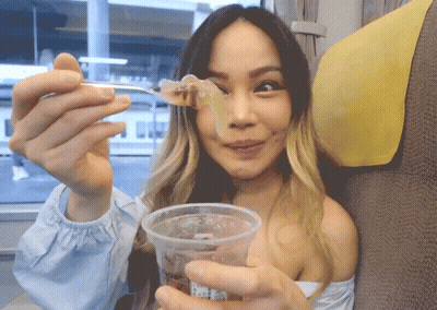Woman Holding Cup And Spoon With Food GIF