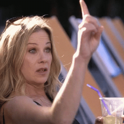 Woman Holding Cup With Straw And Pointing GIF