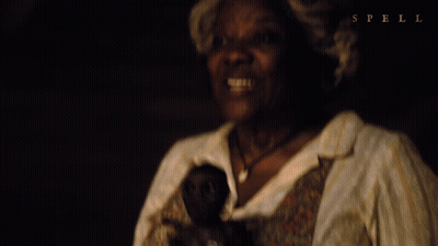 Woman Holding Doll With Spell GIF