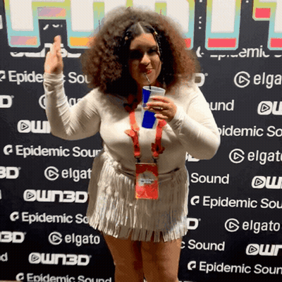 Woman Holding Drink In Front Of Epidemic Sour Wall GIF