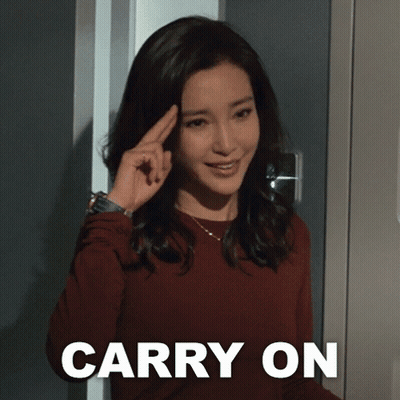 Woman Holding Finger to Forehead in Front of Carry On Sign