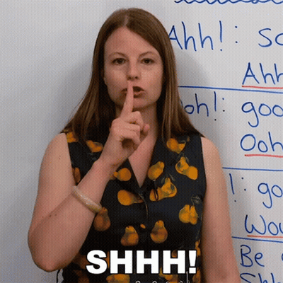 Woman Holding Finger To Lips Shh GIF