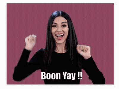 Woman Holding Fists Up Smiling GIF
