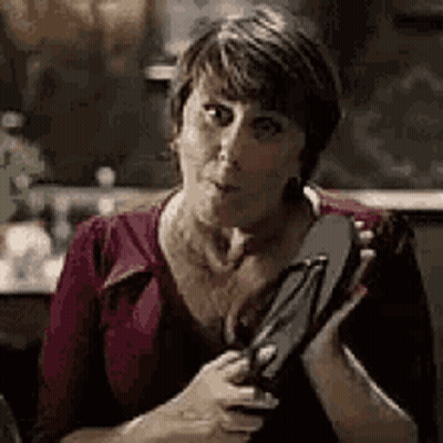 Woman Holding Flip Flops Making Funny Face GIF