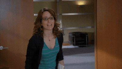 Woman Holding Folder In Front Of Phillies Sign GIF